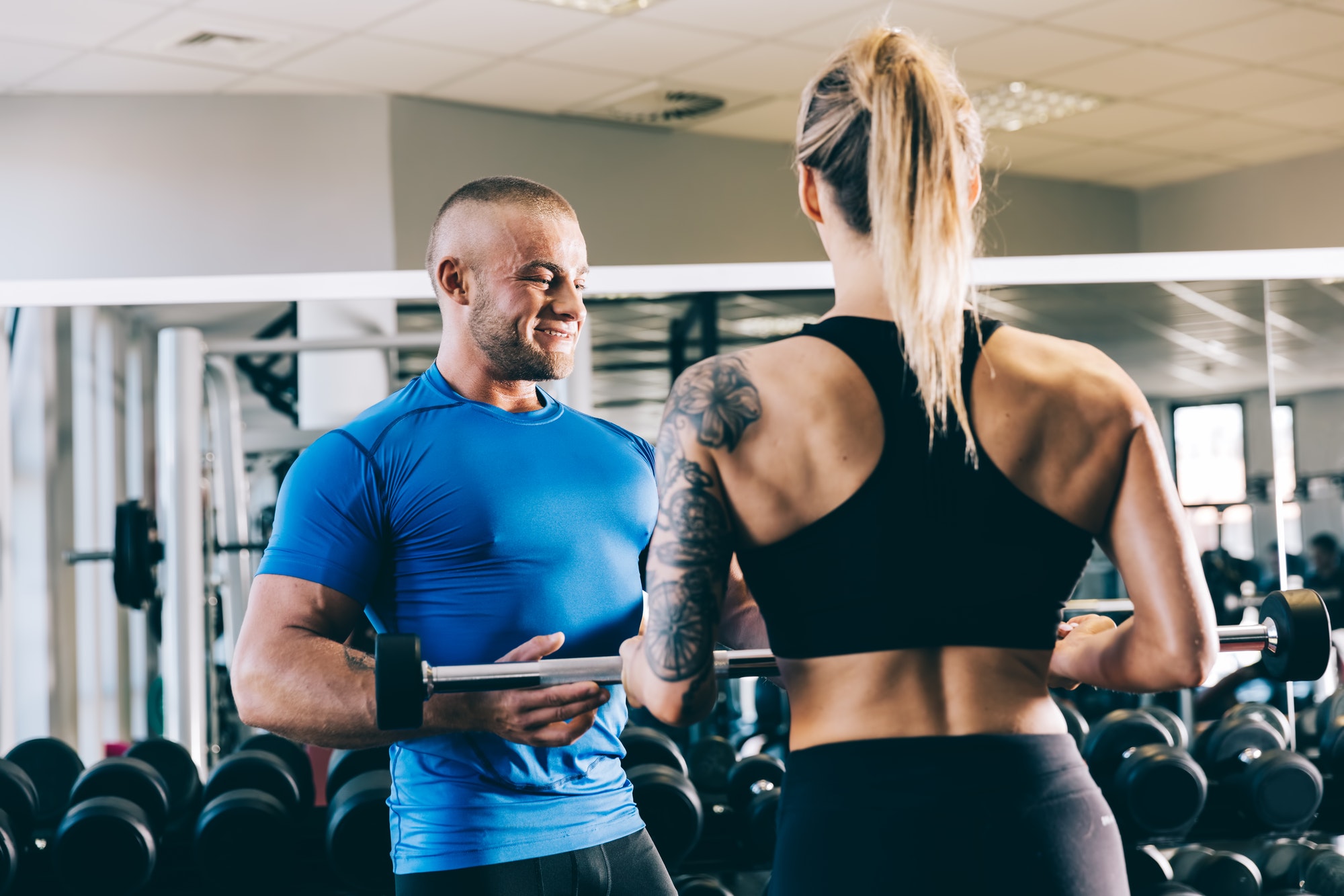 Personal trainer helping a woman with her training.